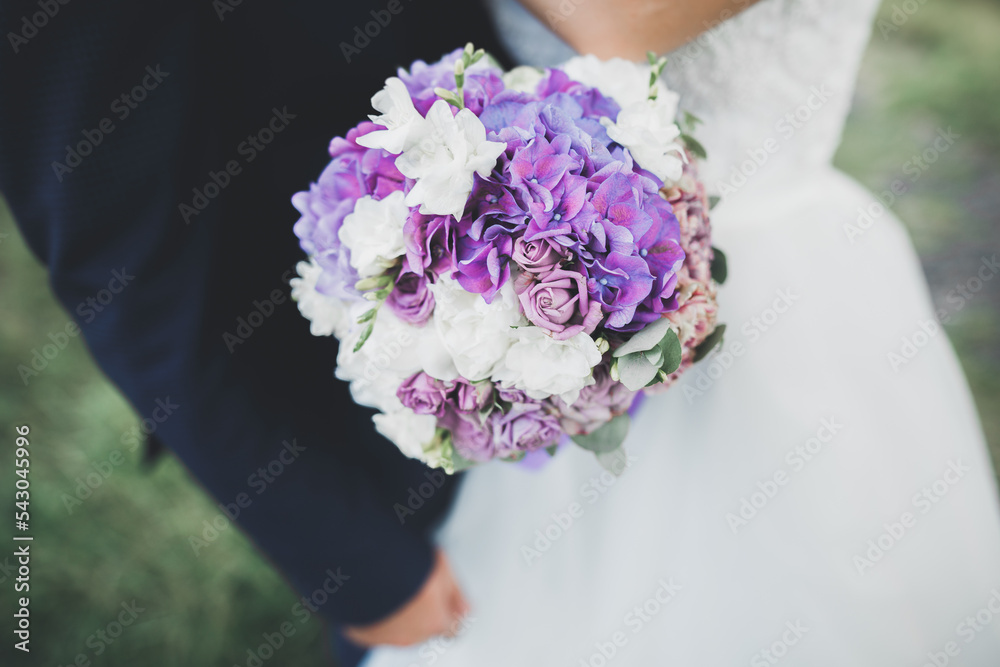 Bride holding big and beautiful wedding bouquet with flowers Bride holding big and beautiful wedding bouquet with flowers