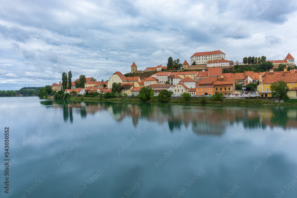 Panoramic of Ptuj city with the Drava river in front of the picture with its reflection in Slovenia.