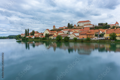 Panoramic of Ptuj city with the Drava river in front of the picture with its reflection in Slovenia.