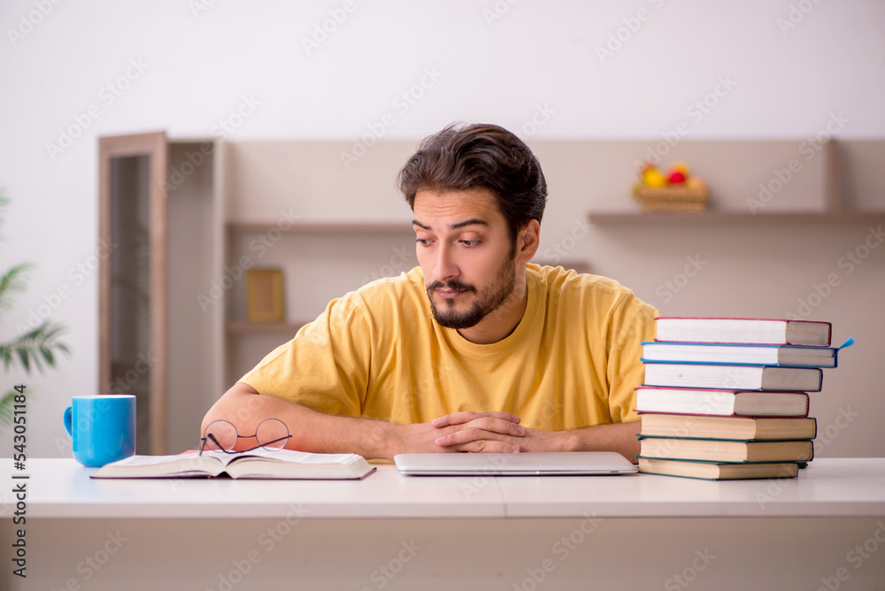 Young male student preparing for exams at home Young male student preparing for exams at home