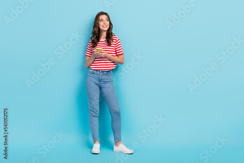 Full length photo of adorable lovely interested look empty space device shopping sale discount isolated on blue color background
