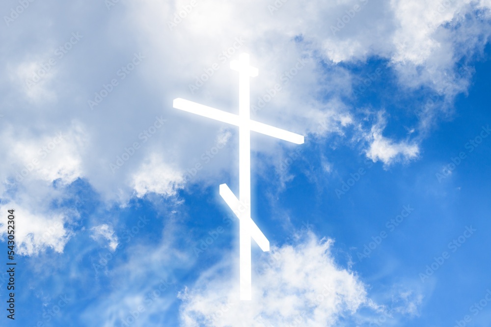 Christian light cross in the blue sky with clouds Christian light cross in the blue sky with clouds