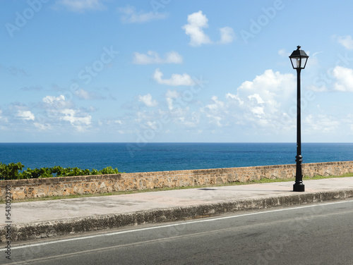 City coast mural street with a lamp post and the ocean in the background from puerto rico san juan el morro