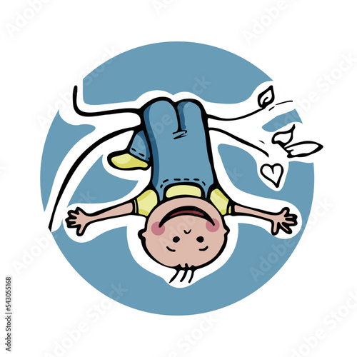 Happy little child hanging upside down on a tree branch