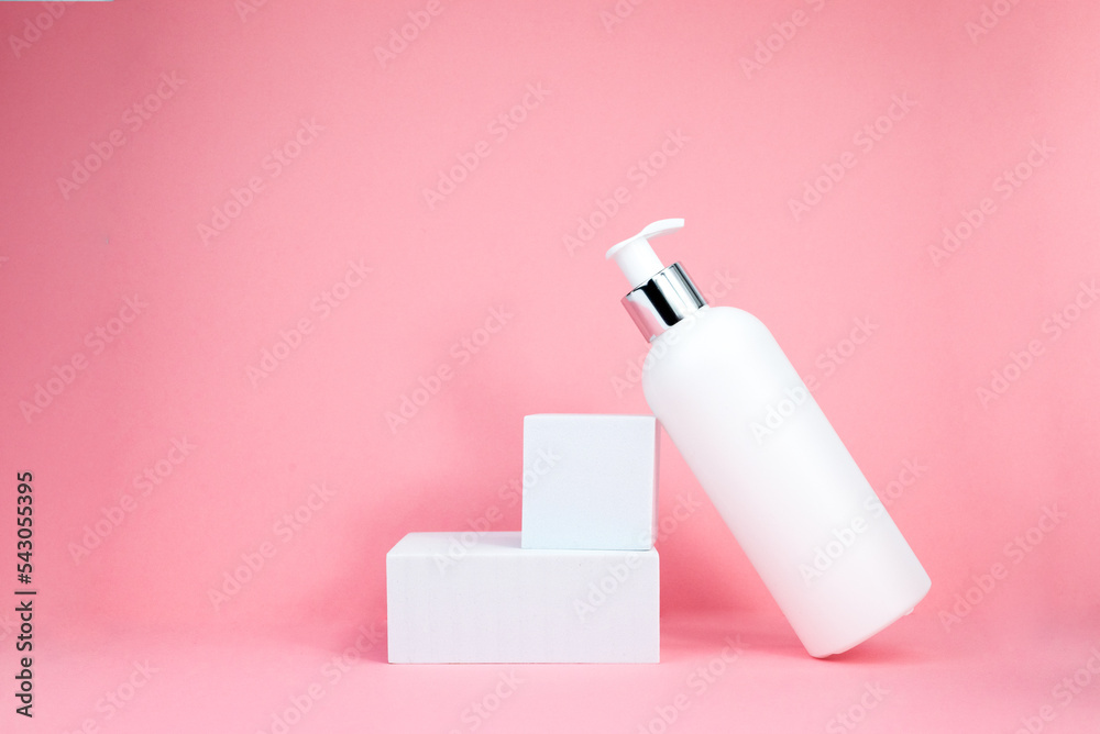 A white cosmetic bottles mockup. White plastic bottles with shampoo and conditioner and shower gel on a pink background. Mockup cosmetic bottle with place to add text on pink background A white cosmetic bottles mockup. White plastic bottles with shampoo and conditioner and shower gel on a pink background. Mockup cosmetic bottle with place to add text on pink background