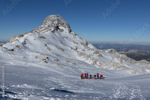 A group of climbers are training on a snowy slope near one of the peaks in the Dachstein region, Austrian Alps photo