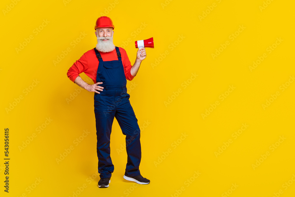 Full size photo of professional workman carpenter use loud speaker proclaim message isolated bright color background Full size photo of professional workman carpenter use loud speaker proclaim message isolated bright color background