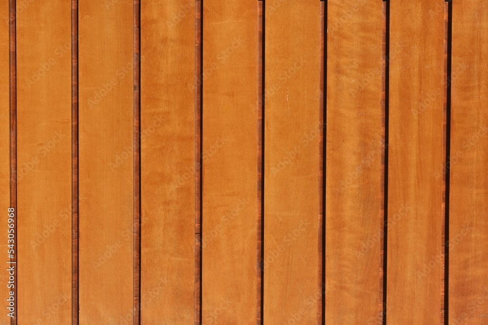 Obraz premium Fondo con detalle y textura de varios listones de madera con vetas y diferentes tonos anaranjados suaves