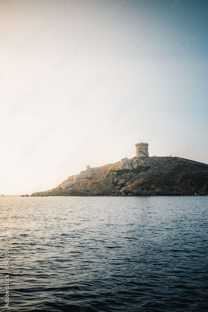 Omigna Tower at sunset in Corsica, France. Genoese tower photography in vertical format. Cargese, Corse