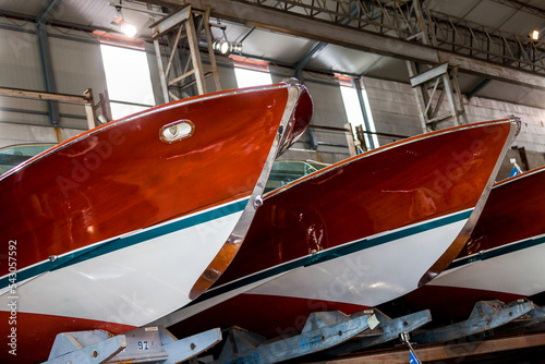 Classic wooden motor boats in shipyard photo