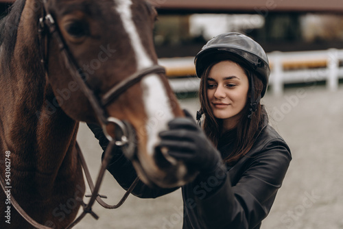 Equestrian competitions. A woman and a horse are preparing for a race. © callisto