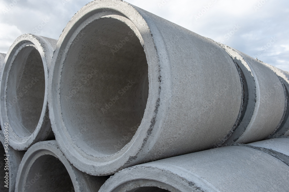 Concrete Shackles piled up in a factory, on a construction site. Basic sanitation works to supply water and sewage to the population. Cement shackles on a lawn. Concrete Shackles piled up in a factory, on a construction site. Basic sanitation works to supply water and sewage to the population. Cement shackles on a lawn.