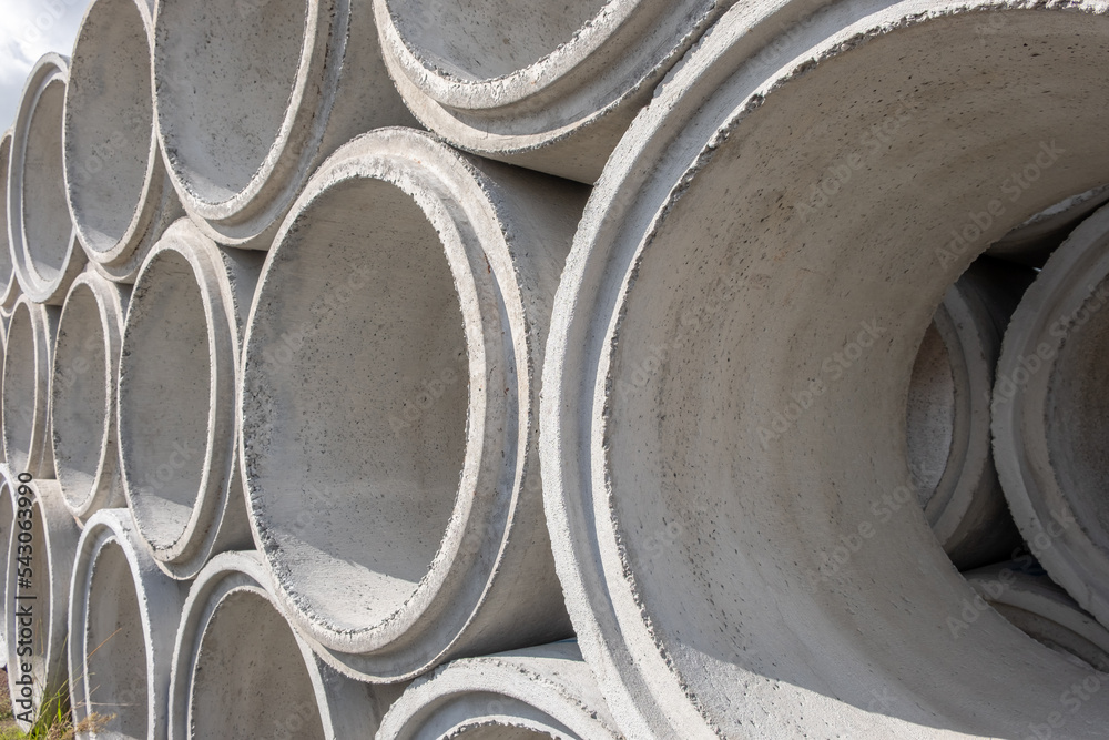 Concrete Shackles pilled up in a factory, on a construction site. Basic sanitation works to supply water and sewage to the population. Cement shackles aligned on top.