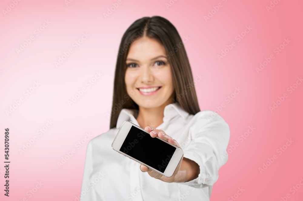 Happy young girl with modern smartphone with a blank screen