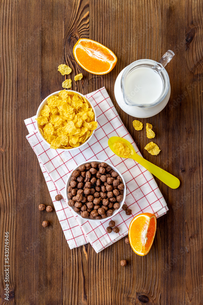 Children breakfast with snack - cereals with oranges, top view Children breakfast with snack - cereals with oranges, top view