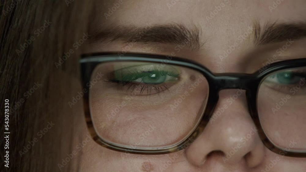 Close up portrait of trader woman in glasses with forex chart reflection of stock market graphs in broker glasses. The concept of international trading and overworking in a huge investment fund Close up portrait of trader woman in glasses with forex chart reflection of stock market graphs in broker glasses. The concept of international trading and overworking in a huge investment fund