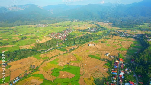 Aerial view over rice fields and villages in Nan Province, Northern Thailand. Agriculture industry in Asia. Green nature background. 4k. drones
 photo