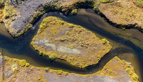 birdview of a tundra island surrounded by river with meadows and moss photo