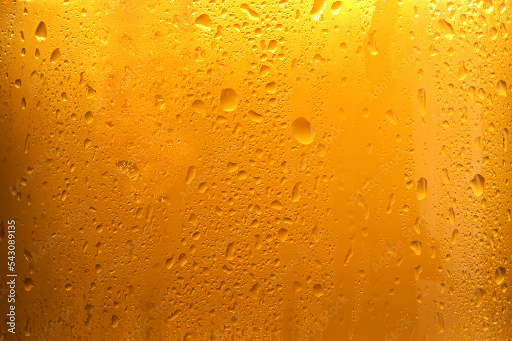 Glass of tasty cold beer with condensation drops as background, closeup Glass of tasty cold beer with condensation drops as background, closeup