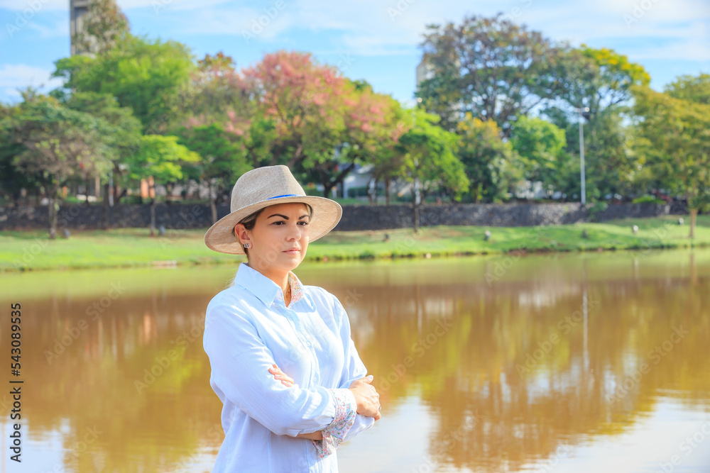 Agribusiness woman wearing hat and jeans at the end of a working day.. Agribusiness woman wearing hat and jeans at the end of a working day..