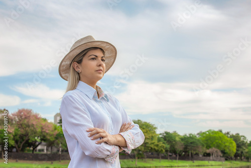 Agribusiness woman wearing hat and jeans at the end of a working day..