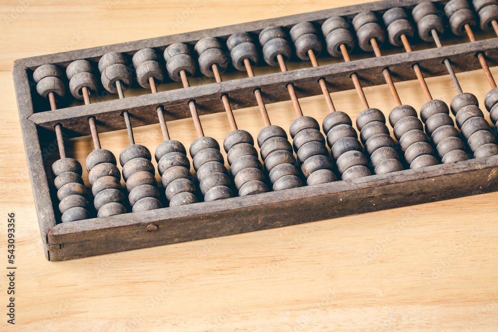 Chinese traditional calculator, old abacus on wooden background Chinese traditional calculator, old abacus on wooden background