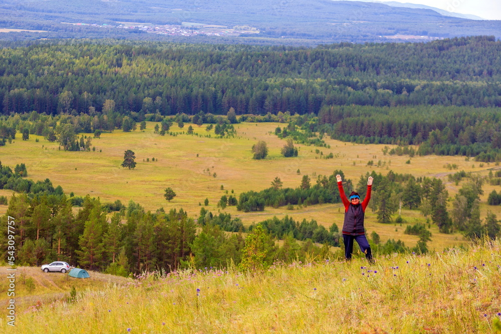 beautiful mature woman traveler enjoys the nature of the southern Urals