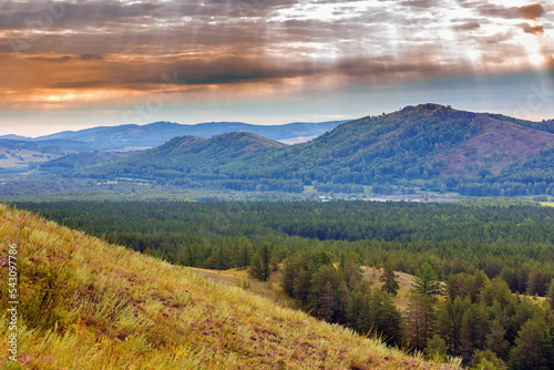 South Ural, Ural mountains in summer. Sunset in the mountains. The top of the mountain range. Summer day.