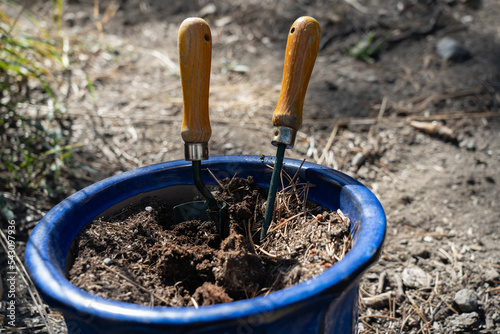 Garden tools in empty pot