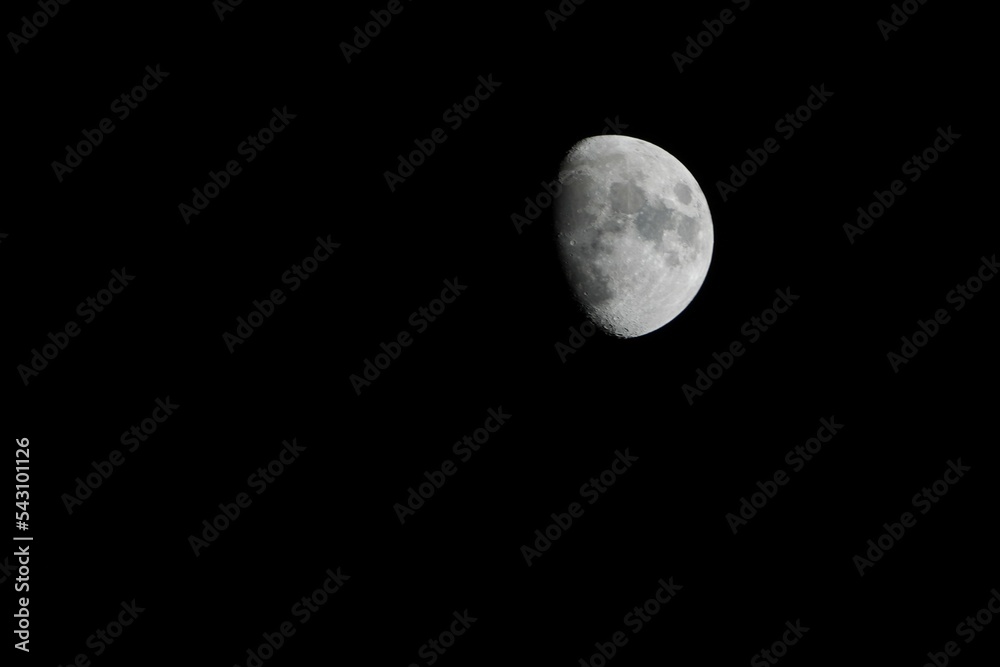 Blurred photo, at night, the moon is visible in the distance. Blurred photo, at night, the moon is visible in the distance.