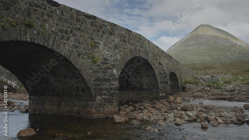Low angle view of Sligachan Bridge over rocks in river / Sligachan, Scotland photo