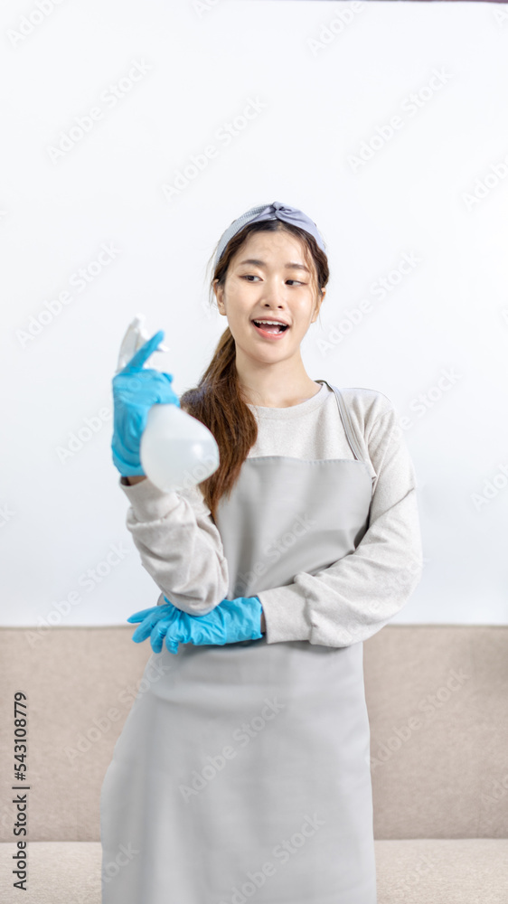 Beautiful Asian housewife wearing apron and cleaning gloves prepares to clean her house, Housework, Daily routine, Big cleaning, Clean and remove germs and dirt in the house, Clean up on weekends. Beautiful Asian housewife wearing apron and cleaning gloves prepares to clean her house, Housework, Daily routine, Big cleaning, Clean and remove germs and dirt in the house, Clean up on weekends.