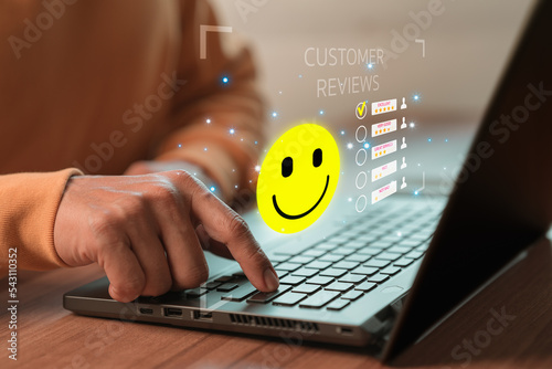 Man hand using computer laptop with popup five star icon for feedback review satisfaction service, testimonial. Customer service experience and business satisfaction survey.