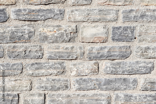 A close up background of grey natural stone wall