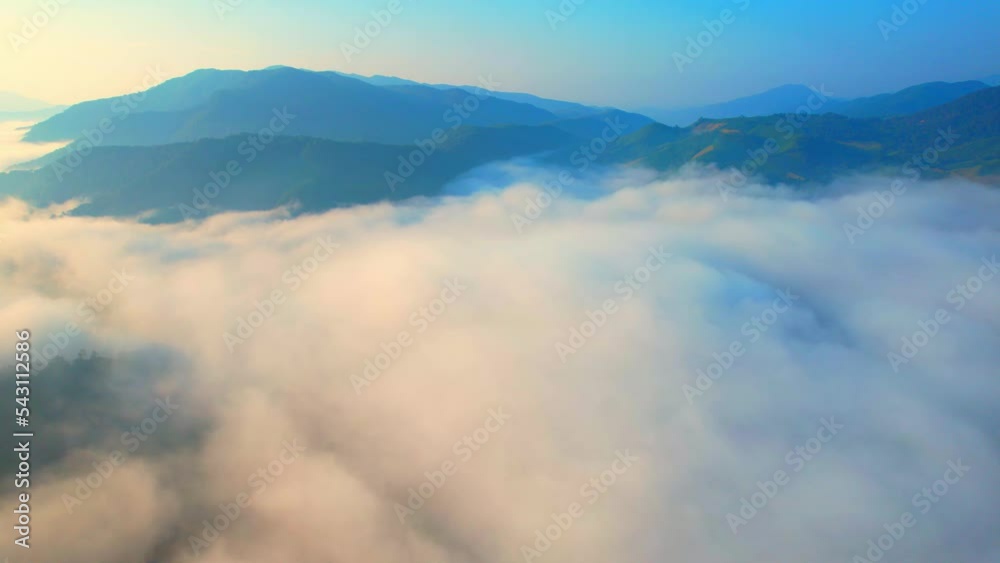 Aerial view over heavy fog in a tropical forest at sunrise, tropical winter. Bo Kluea District, Nan Province, Northern Thailand. travel thailand. Forest Landscape concept. 4k footage
