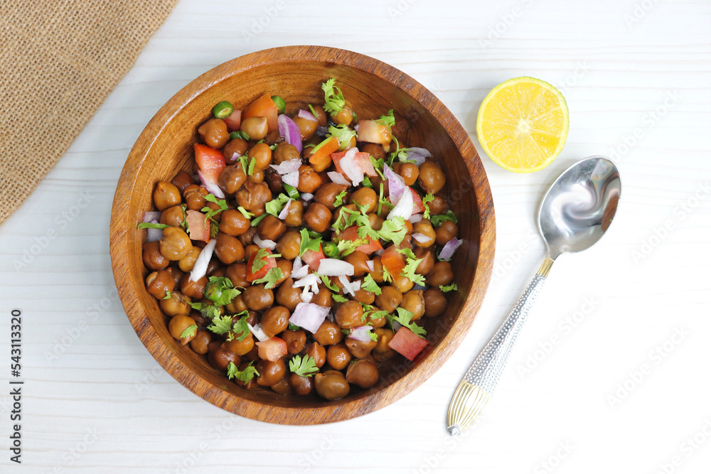 High in protine boiled black chana or chickpea salad. Chopped tomatoes, onion, chilies, and coriander mixed with boiled chickpea or Bengal gram. Weight loss meal. Served with Lemon. Copy space. High in protine boiled black chana or chickpea salad. Chopped tomatoes, onion, chilies, and coriander mixed with boiled chickpea or Bengal gram. Weight loss meal. Served with Lemon. Copy space.