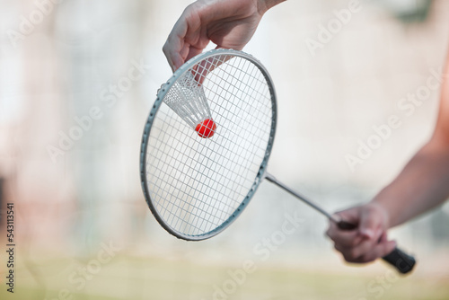 Sports, badminton and shuttlecock with racket and hands of woman training for games, competition and health. Match, workout and exercise with athlete ready to serve for goal, fitness and action © Talia M/peopleimages.com