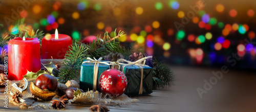 traditional christmas decoration on a table witjh candles and colorful light ...