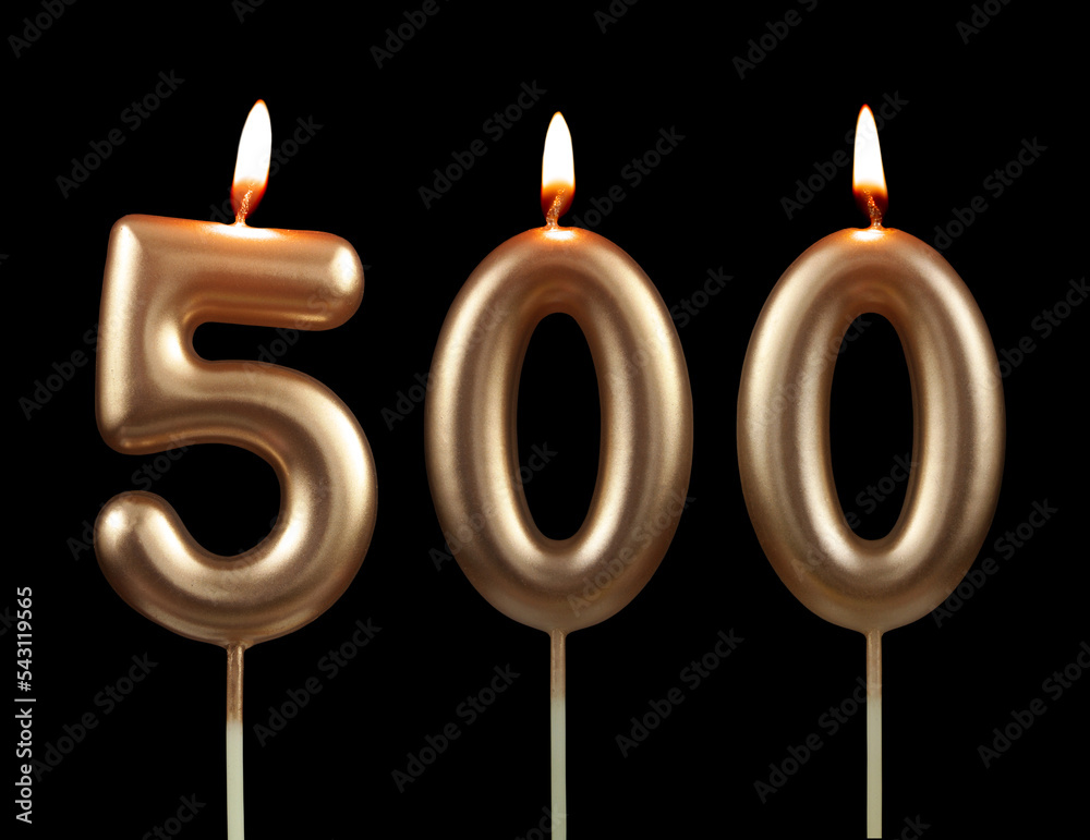 Burning gold birthday candles isolated on black background, number 500 Burning gold birthday candles isolated on black background, number 500