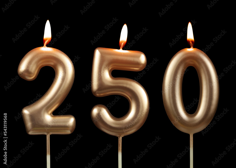 Burning golden birthday candles isolated on black background, number 250 Burning golden birthday candles isolated on black background, number 250