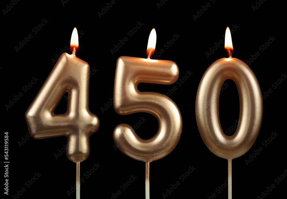 Burning golden birthday candles isolated on black background, number 450 Burning golden birthday candles isolated on black background, number 450