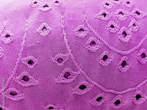 Pink fabric texture with micropores and hole designs. macro photo