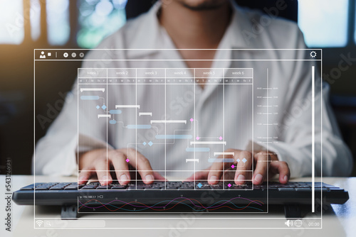 Businessman using keyboard and virtual screen with Gantt chart scheduling virtual diagram, Project management schedule plan diagram business process optimisation, deadline, concept.