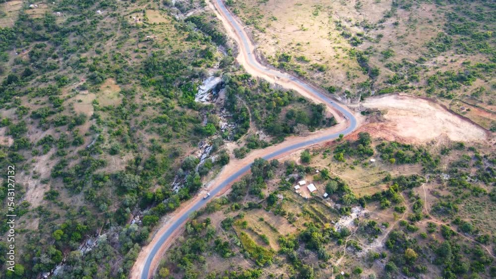 Commercial road at Kapenguria Kenya with the unique design. Road design passing through the forest. Drone flying over the long road Kenya. Commercial road at Kapenguria Kenya with the unique design. Road design passing through the forest. Drone flying over the long road Kenya.