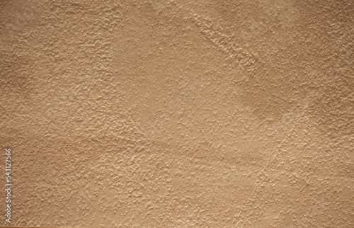 Brown background from decorative plaster with abstract spots. Unusual beige wall texture with beautiful patterns, creative surface background. Front covering for facing of buildings.