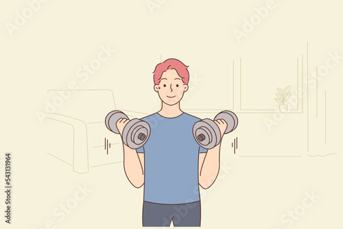 Young man with barbells train at home 
