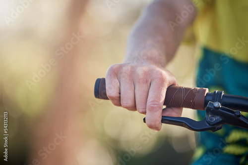 Bike, travel and hands of cycling man riding a bicycle for cardio training, fitness workout or exercise for marathon race. Mountain bike, handle bar and adventure person on freedom journey in nature