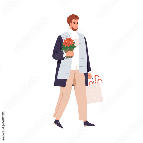 Happy man carrying Christmas plant, poinsettia in pot and shopping bag with X...