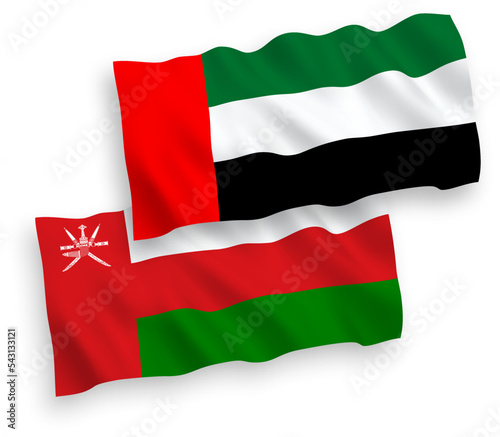 National vector fabric wave flags of Sultanate of Oman and United Arab Emirates isolated on white background. 1 to 2 proportion.