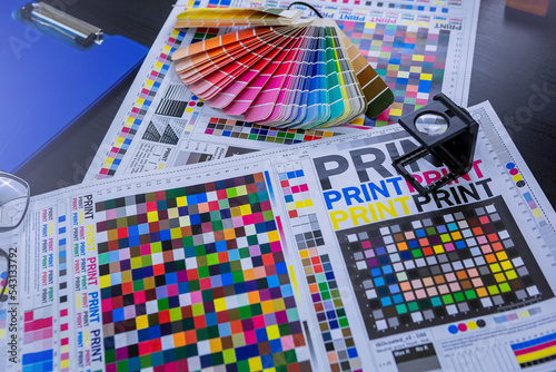 Magnifying glasses for checking print quality of media graphics proof print in printing industry. Selected focus photo